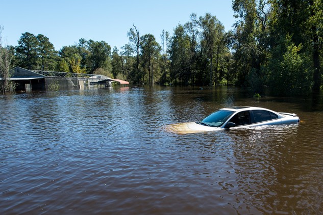 Image of car in flood waters.